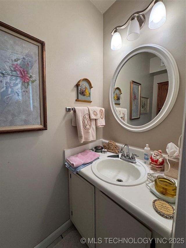 bathroom with baseboards and vanity