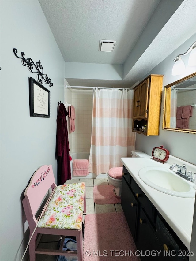 full bath with a textured ceiling, toilet, vanity, visible vents, and tile patterned floors