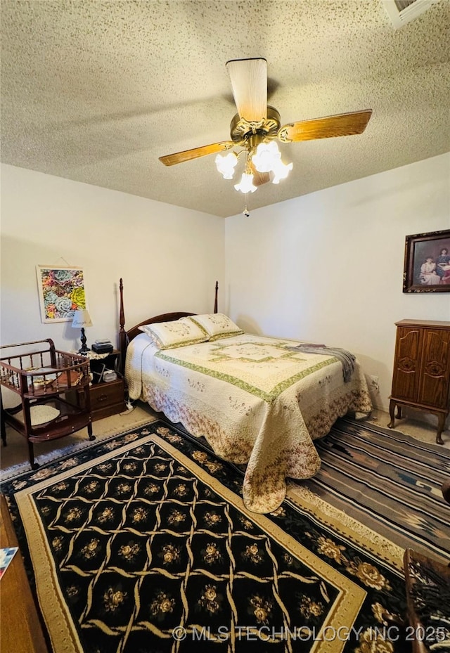 bedroom featuring carpet, ceiling fan, and a textured ceiling