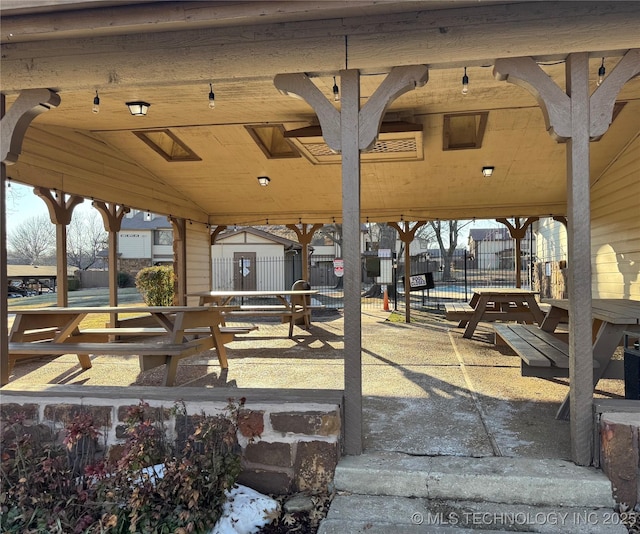 view of community featuring fence
