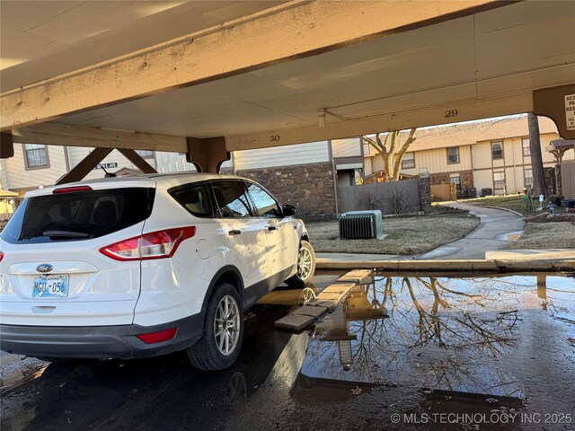 view of vehicle parking featuring fence
