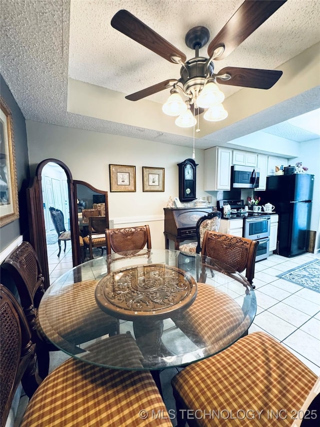 6371 S 80th E Ave Unit 6H, Tulsa, OK 74133 - dining room with a textured ceiling, light tile patterned floors, ceiling fan, and plenty of natural light