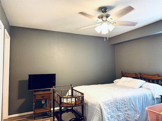 bedroom with a ceiling fan and wood finished floors