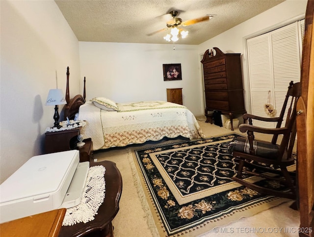 6371 S 80th E Ave Unit 6H, Tulsa, OK 74133 - carpeted bedroom with a textured ceiling, a closet, and ceiling fan