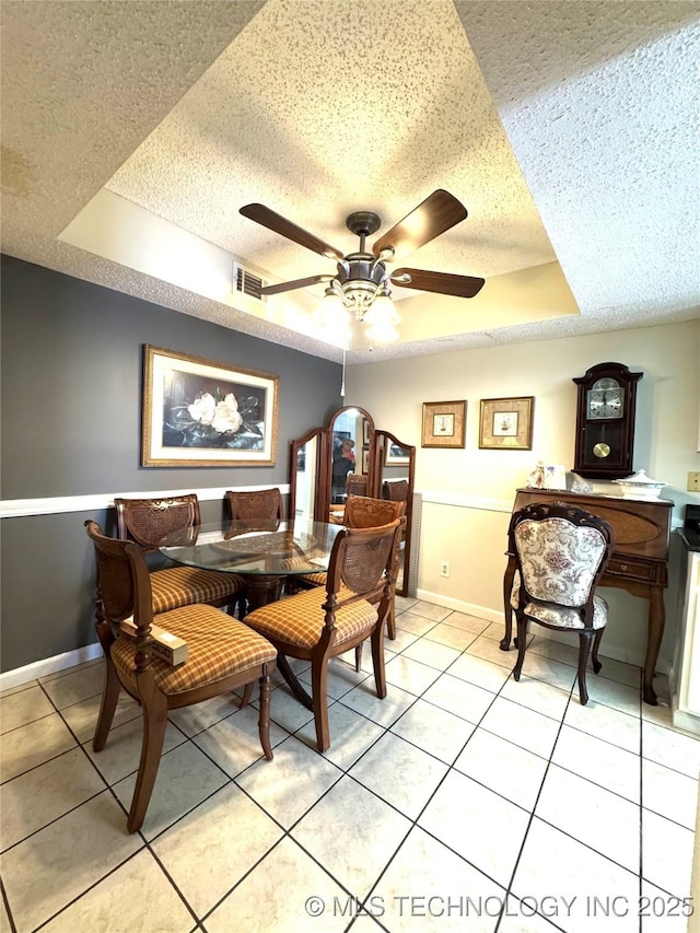6371 S 80th E Ave Unit 6H, Tulsa, OK 74133 - dining room with a raised ceiling, ceiling fan, a textured ceiling, and light tile patterned floors