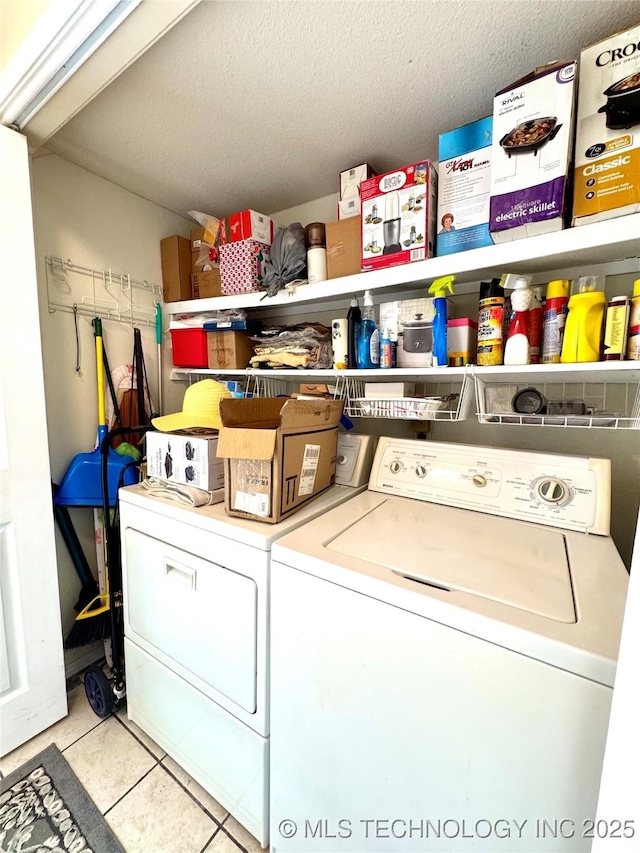 6371 S 80th E Ave Unit 6H, Tulsa, OK 74133 - laundry room featuring washer and dryer, a textured ceiling, and tile patterned flooring