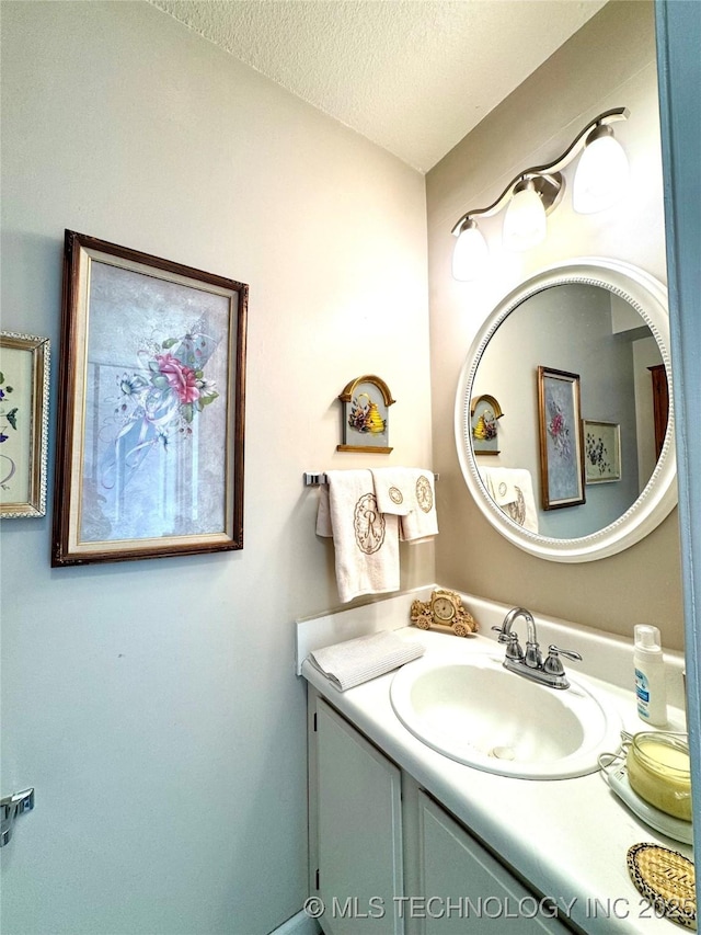 bathroom with vanity and a textured ceiling