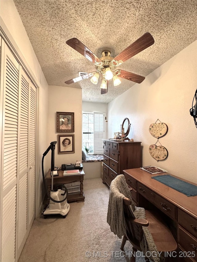 carpeted bedroom with a ceiling fan, a textured ceiling, and a closet
