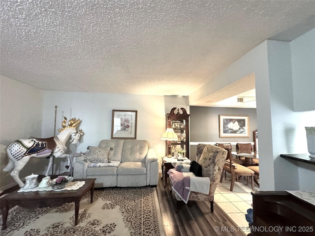 living area with a textured ceiling