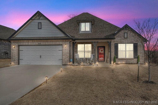 view of front of home featuring concrete driveway, brick siding, and an attached garage