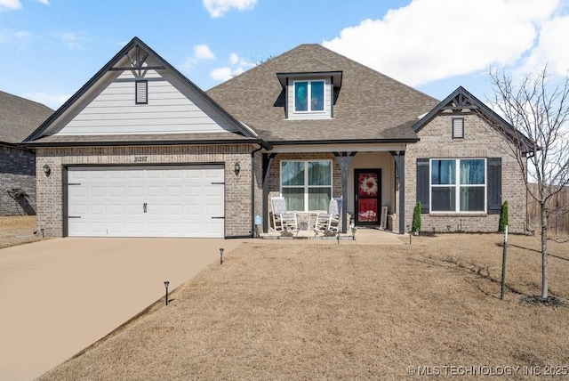 view of front of house with a garage, concrete driveway, and brick siding