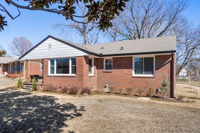 view of front of property with brick siding and crawl space