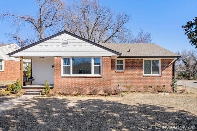 view of front of property featuring crawl space and brick siding