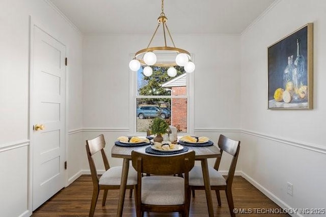 dining area featuring baseboards, wood finished floors, and crown molding