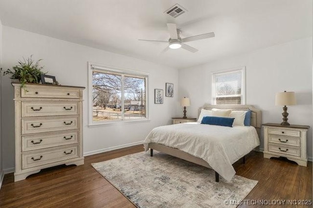 bedroom featuring baseboards, visible vents, ceiling fan, and dark wood-type flooring