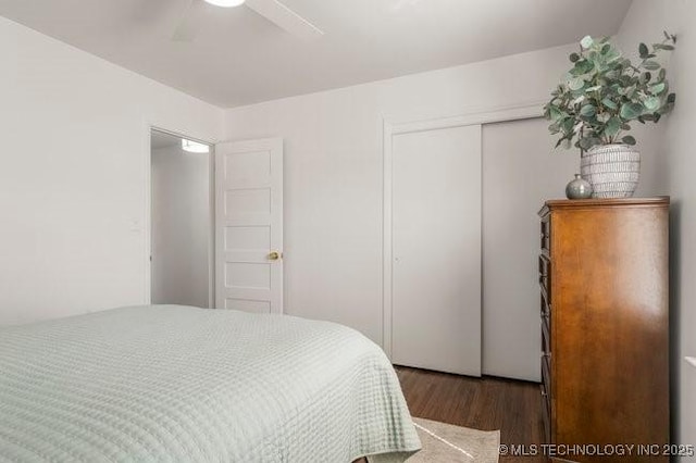 bedroom featuring ceiling fan, a closet, and wood finished floors