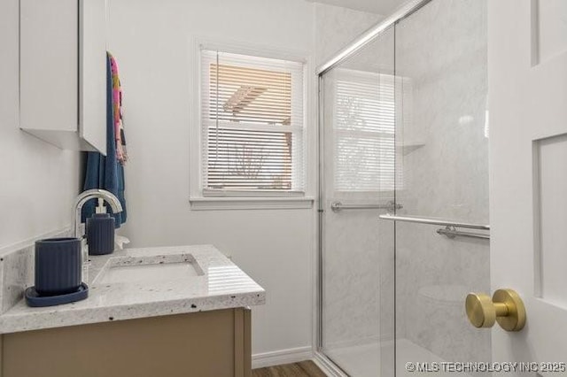 full bathroom with a stall shower and vanity