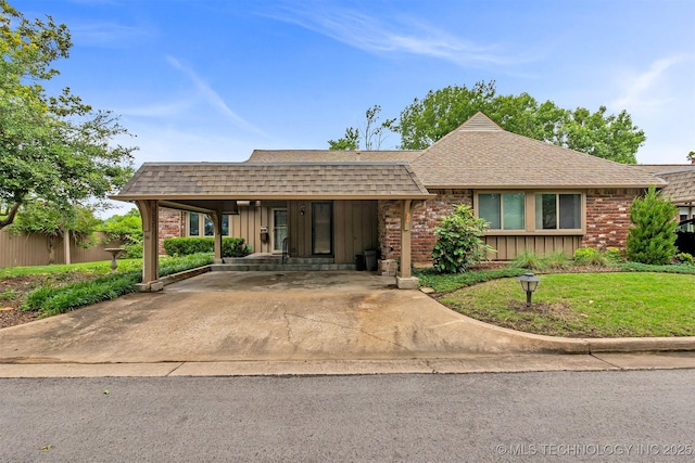 view of front of house with a shingled roof, brick siding, driveway, and board and batten siding