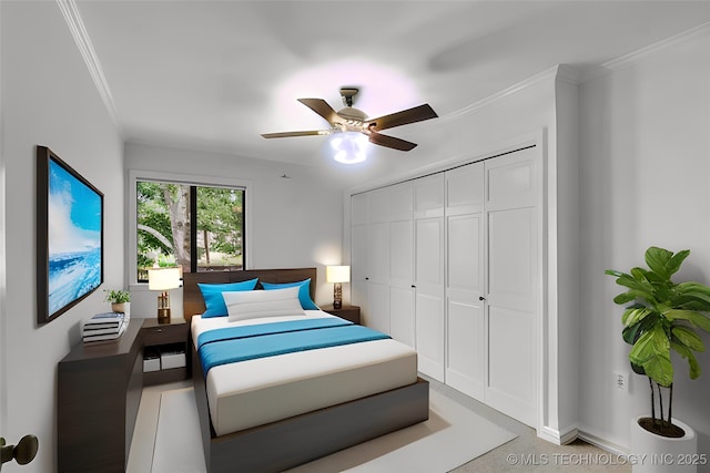 bedroom with baseboards, a closet, a ceiling fan, and crown molding