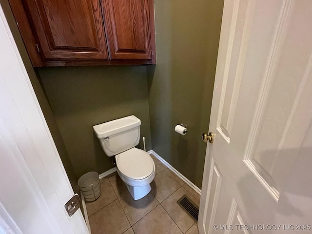 bathroom with toilet, baseboards, visible vents, and tile patterned floors