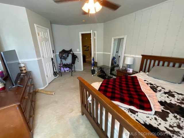 bedroom featuring light carpet and ceiling fan