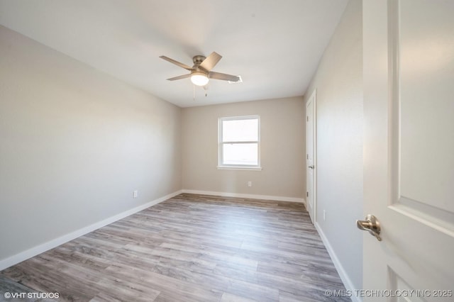 empty room with ceiling fan, baseboards, and light wood-style flooring