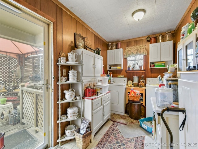 kitchen featuring wood walls, white cabinetry, and light countertops