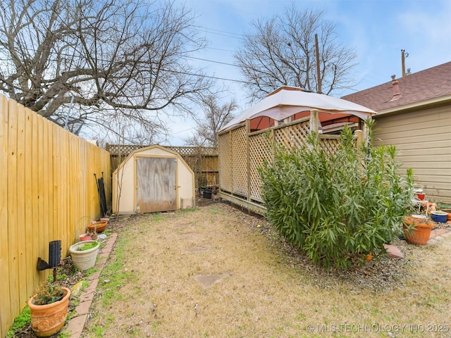 view of yard featuring a storage shed, a gazebo, an outdoor structure, and a fenced backyard