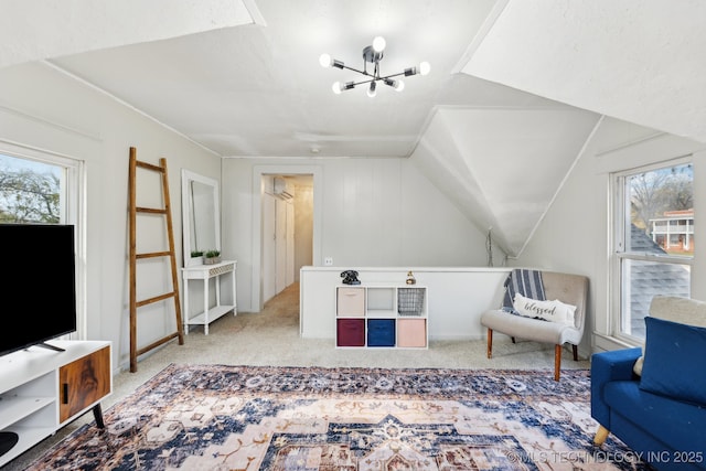 interior space featuring light carpet, plenty of natural light, lofted ceiling, and an inviting chandelier