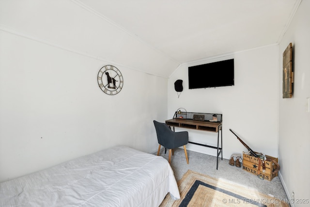 bedroom featuring lofted ceiling, baseboards, and carpet