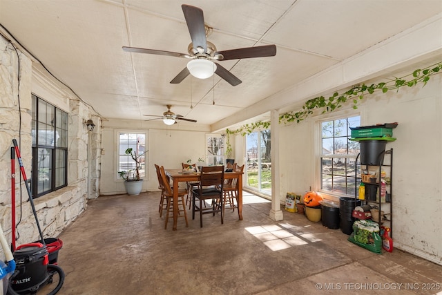 dining area featuring concrete flooring and plenty of natural light