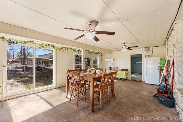 dining room featuring ceiling fan and concrete flooring