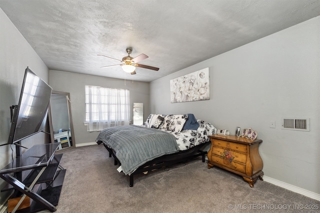 carpeted bedroom featuring visible vents, ceiling fan, a textured ceiling, and baseboards