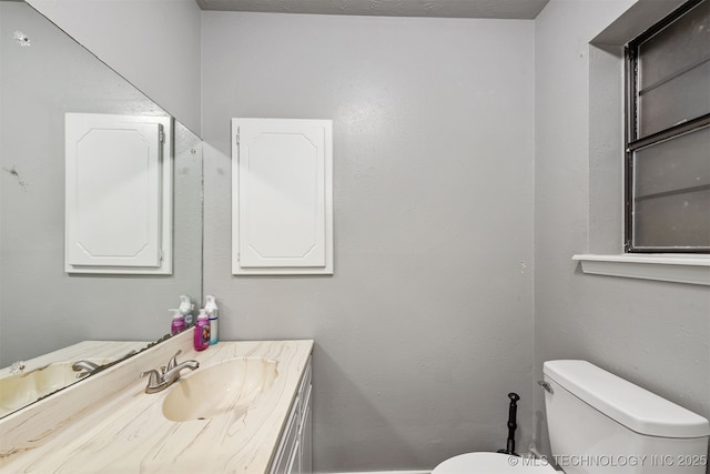 bathroom featuring toilet and vanity