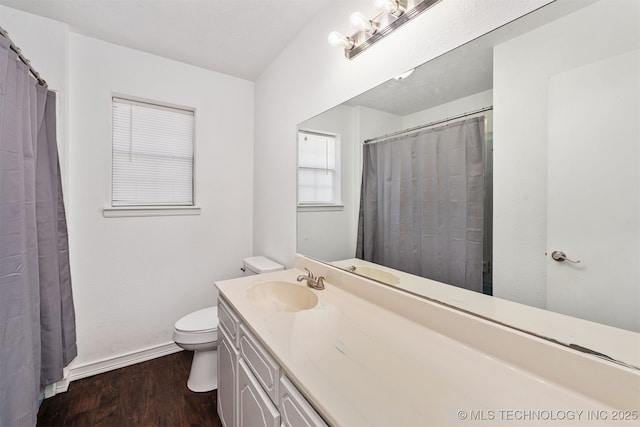 full bathroom with toilet, a shower with shower curtain, wood finished floors, vanity, and baseboards