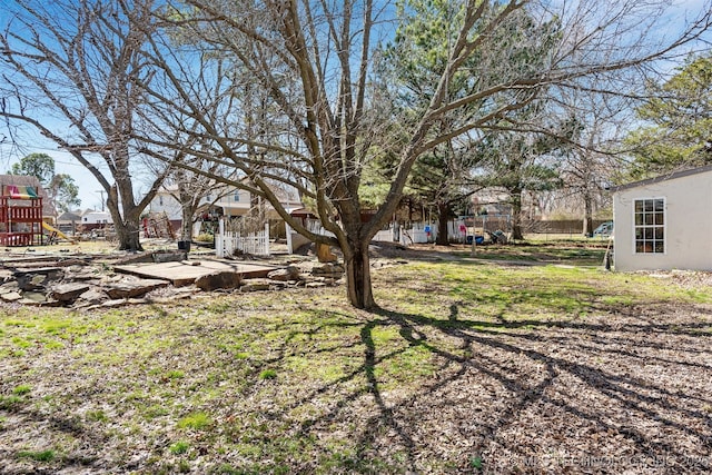 view of yard with fence and a playground