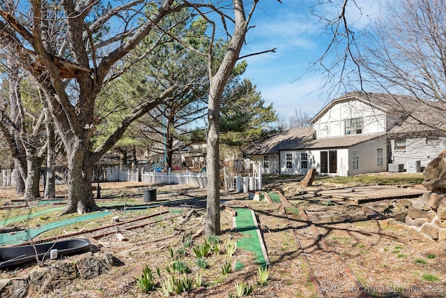 back of house featuring fence and central AC