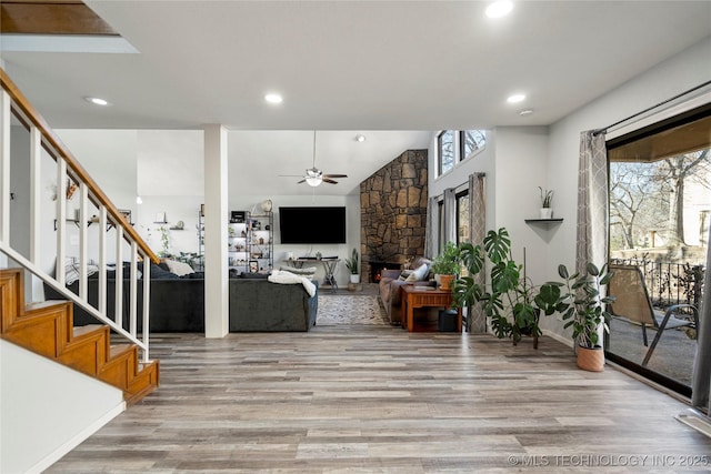living room featuring light wood-style floors, ceiling fan, stairway, and recessed lighting
