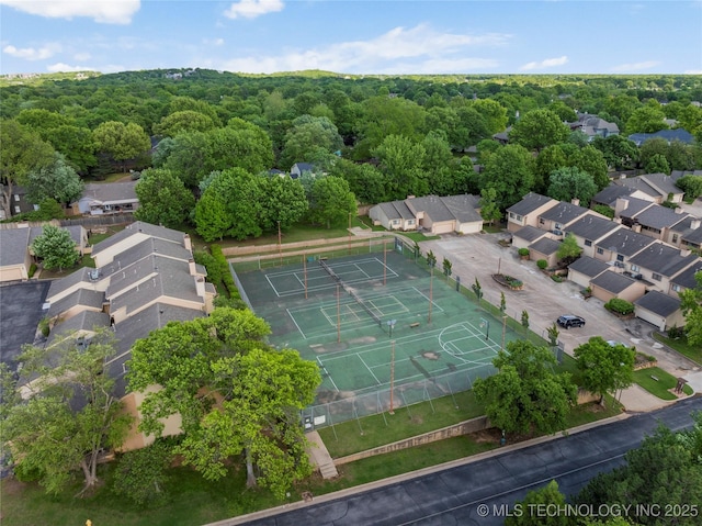birds eye view of property with a view of trees and a residential view