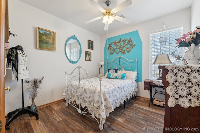 bedroom featuring dark wood-type flooring, a ceiling fan, and baseboards