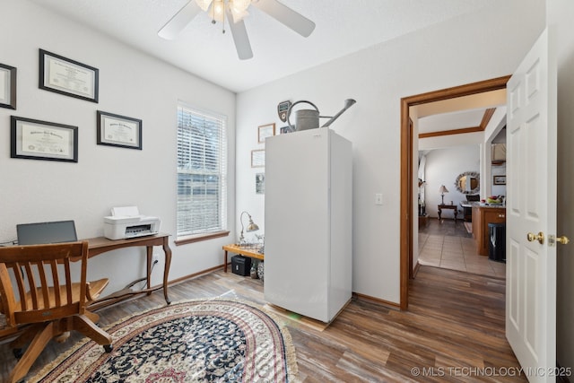 office area featuring wood finished floors, a ceiling fan, and baseboards