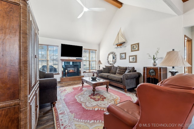 living area with ceiling fan, wood finished floors, a fireplace, high vaulted ceiling, and beam ceiling