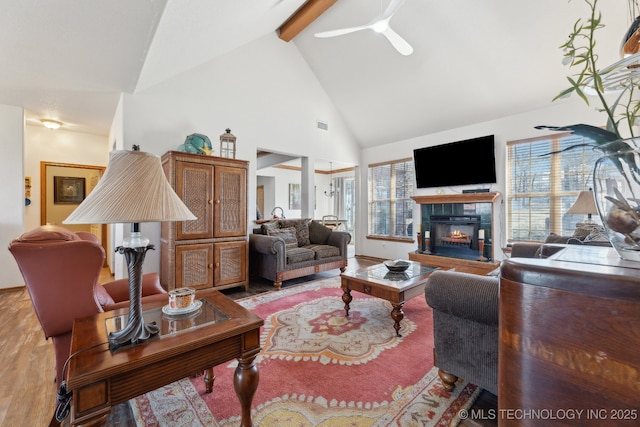 2445 Avalon, Eufaula, OK 74432 - living area featuring high vaulted ceiling, beam ceiling, plenty of natural light, a tile fireplace, and light wood finished floors