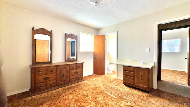 unfurnished bedroom with light carpet, multiple windows, and baseboards