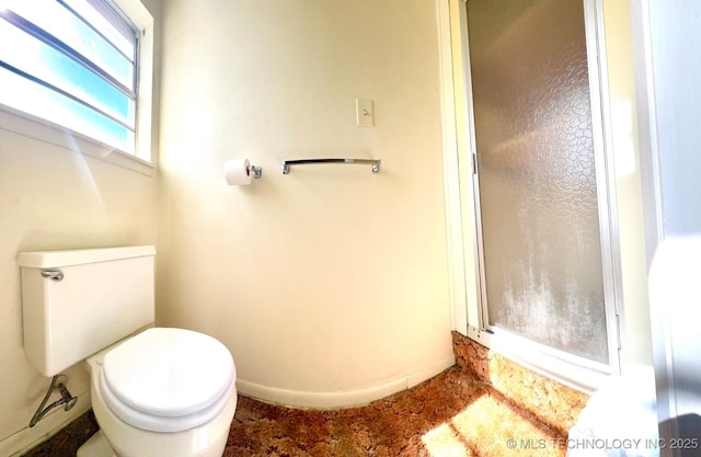 bathroom featuring toilet and baseboards