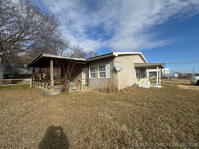 view of side of home with a lawn