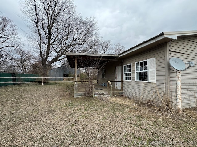 view of side of home with fence