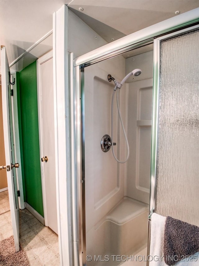 full bathroom with a shower with door and tile patterned floors