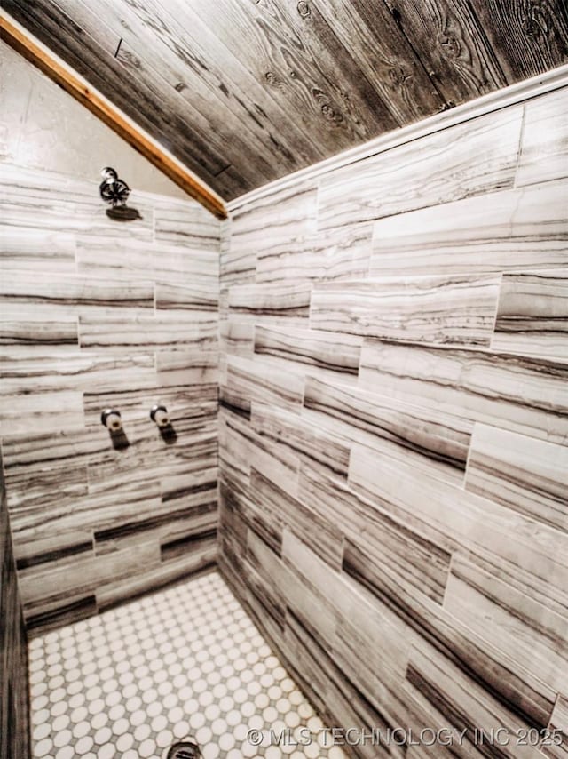 full bath featuring vaulted ceiling and a tile shower