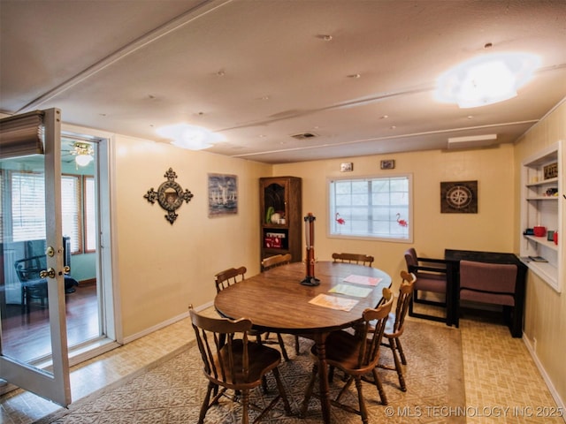 dining area with a healthy amount of sunlight, visible vents, and baseboards